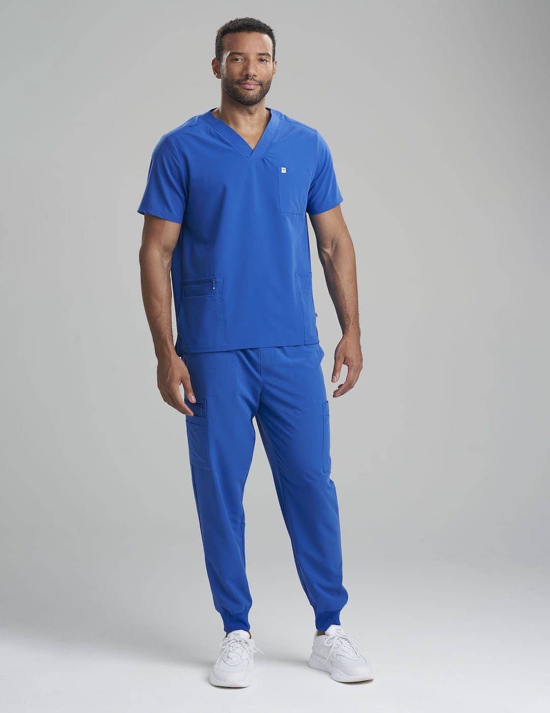 Men's scrub top in royal blue, featuring a classic V-neck cut and seven functional pockets