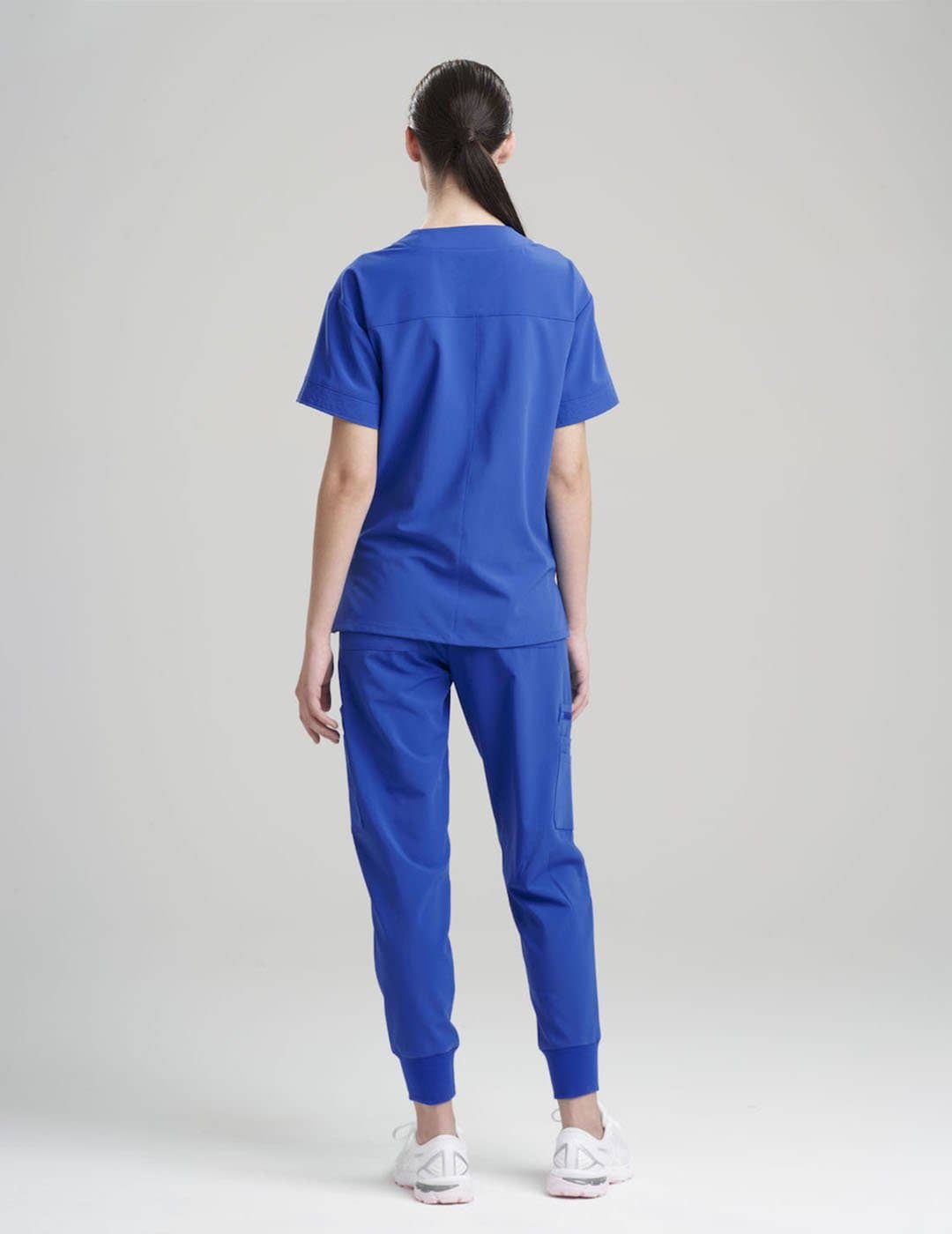 Durable and stylish royal blue V-neck scrub top for women, equipped with eight pockets for all essentials.