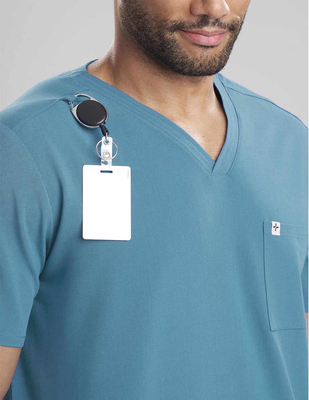 Teal men's V-neck scrub top with three pockets, combining style and practicality