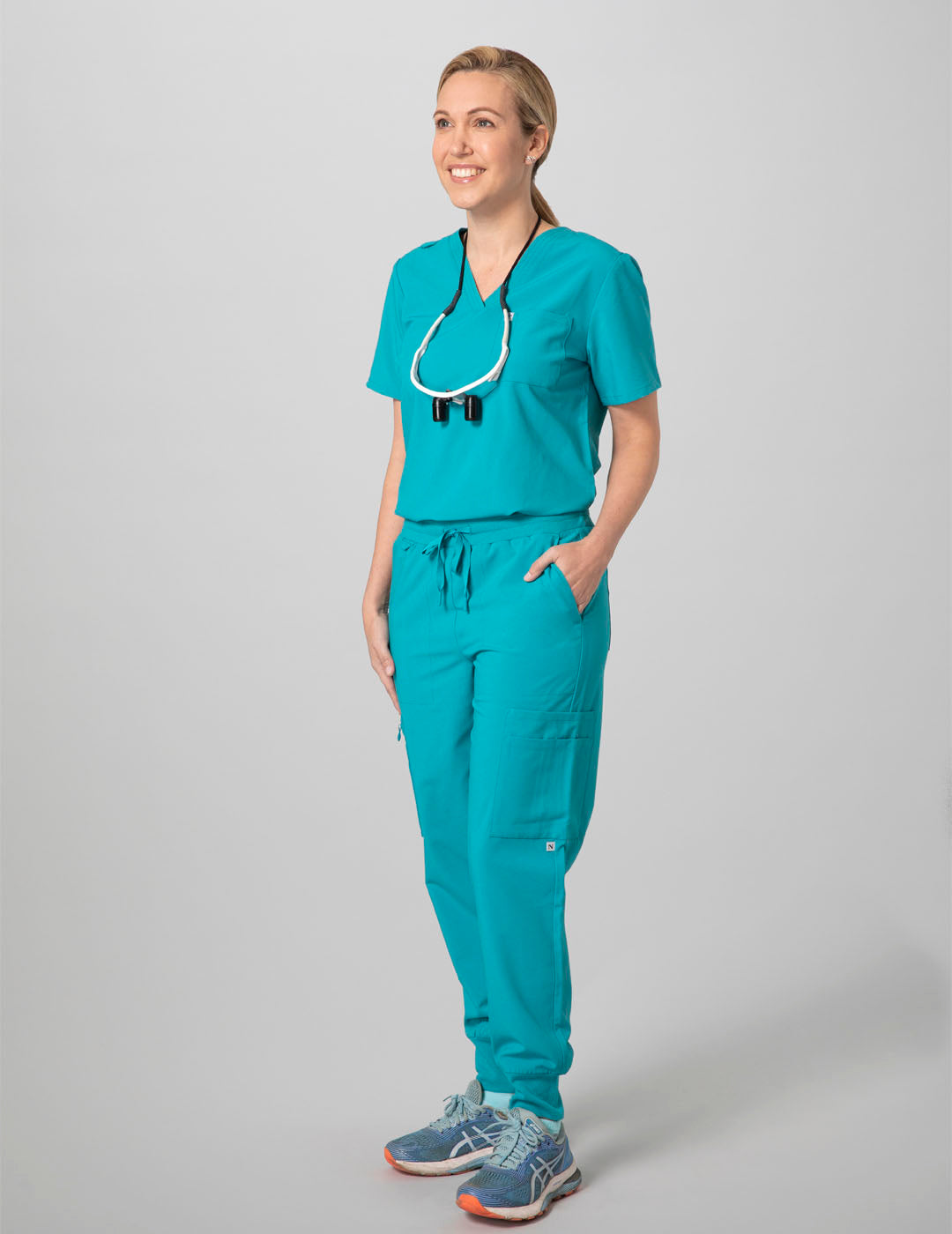 Women&#39;s 12-pocket jogger scrub pants in teal, offering comfort and utility for professional use