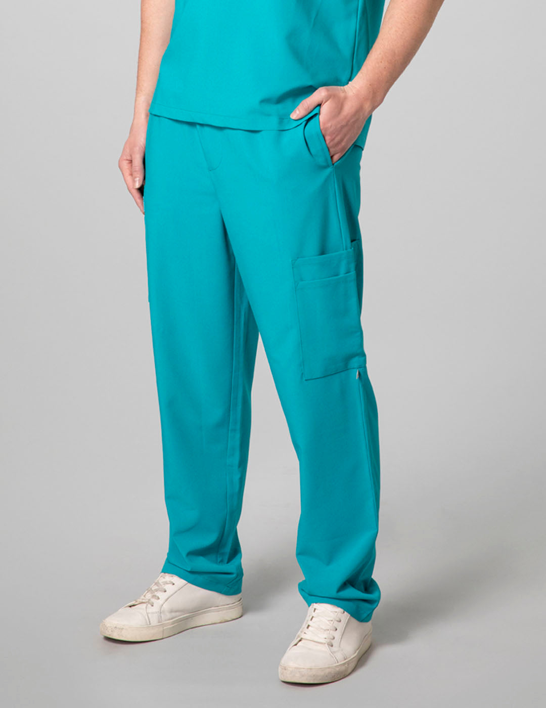 Care+Wear Men's 7-Pocket Straight Leg Scrub Pants in Teal, offering practical design and ample storage for healthcare tasks. Model is wearing size Medium