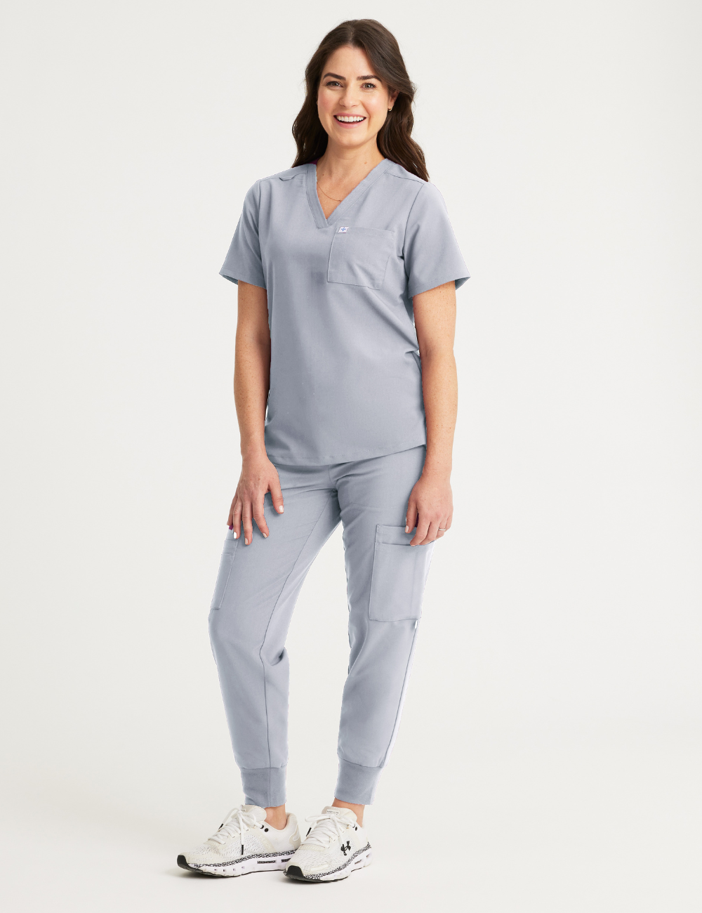 Stylish stone gray scrub top for women, designed with a classic V-neck cut and two convenient pockets