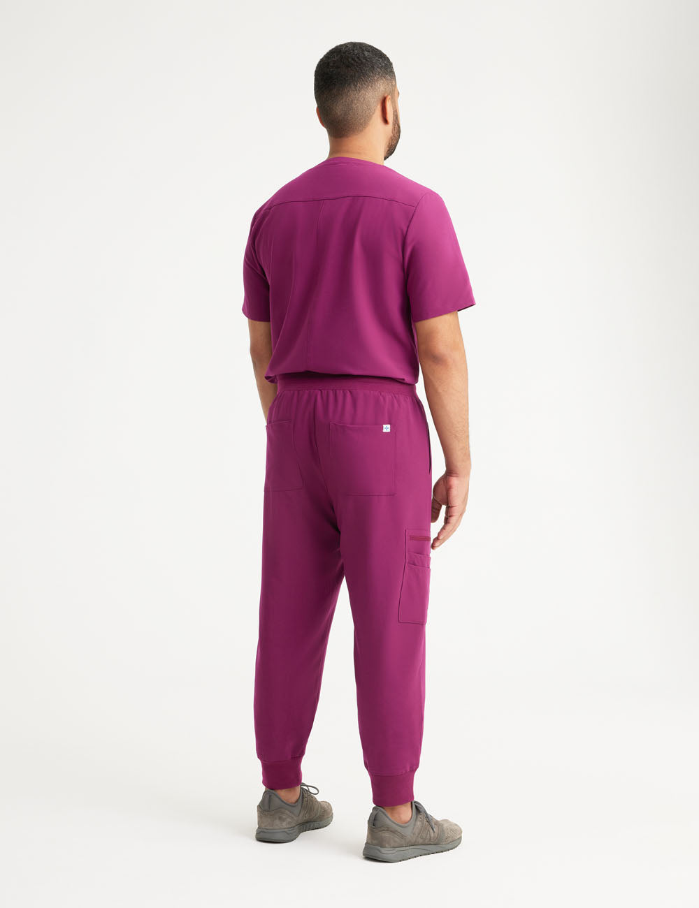 Stylish burgundy men&#39;s scrub jogger pants, crafted for comfort and practicality with multiple pockets