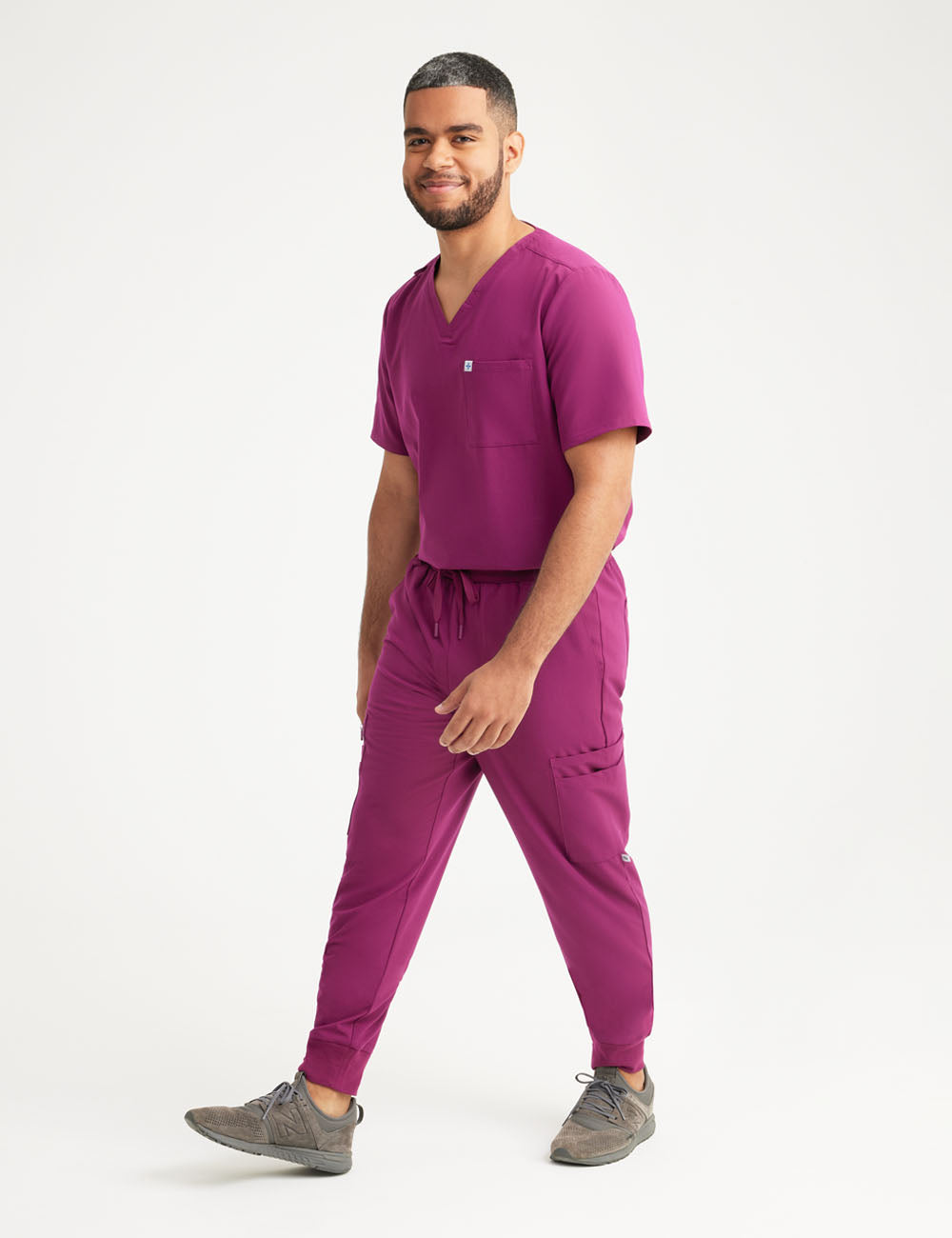 Burgundy men's V-neck scrub top with two pockets, designed for comfort and practicality
