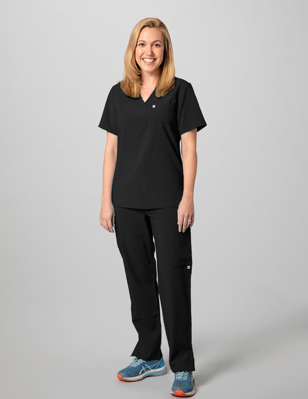 Stylish and versatile black scrub top for women, with a two-pocket layout and classic design