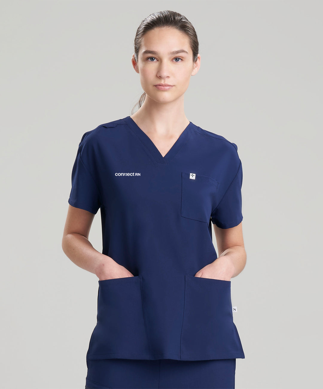 Women's 3-pocket V-neck scrub top in navy, offering a sleek and professional design for healthcare professionals.