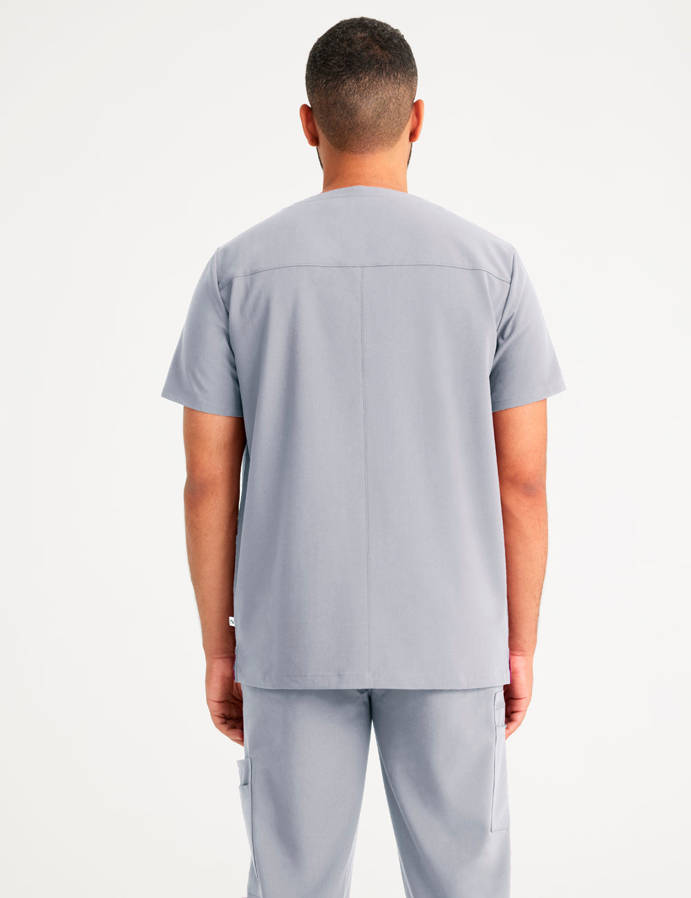 Durable stone gray V-neck scrub top for men, offering comfort and practicality in professional environments