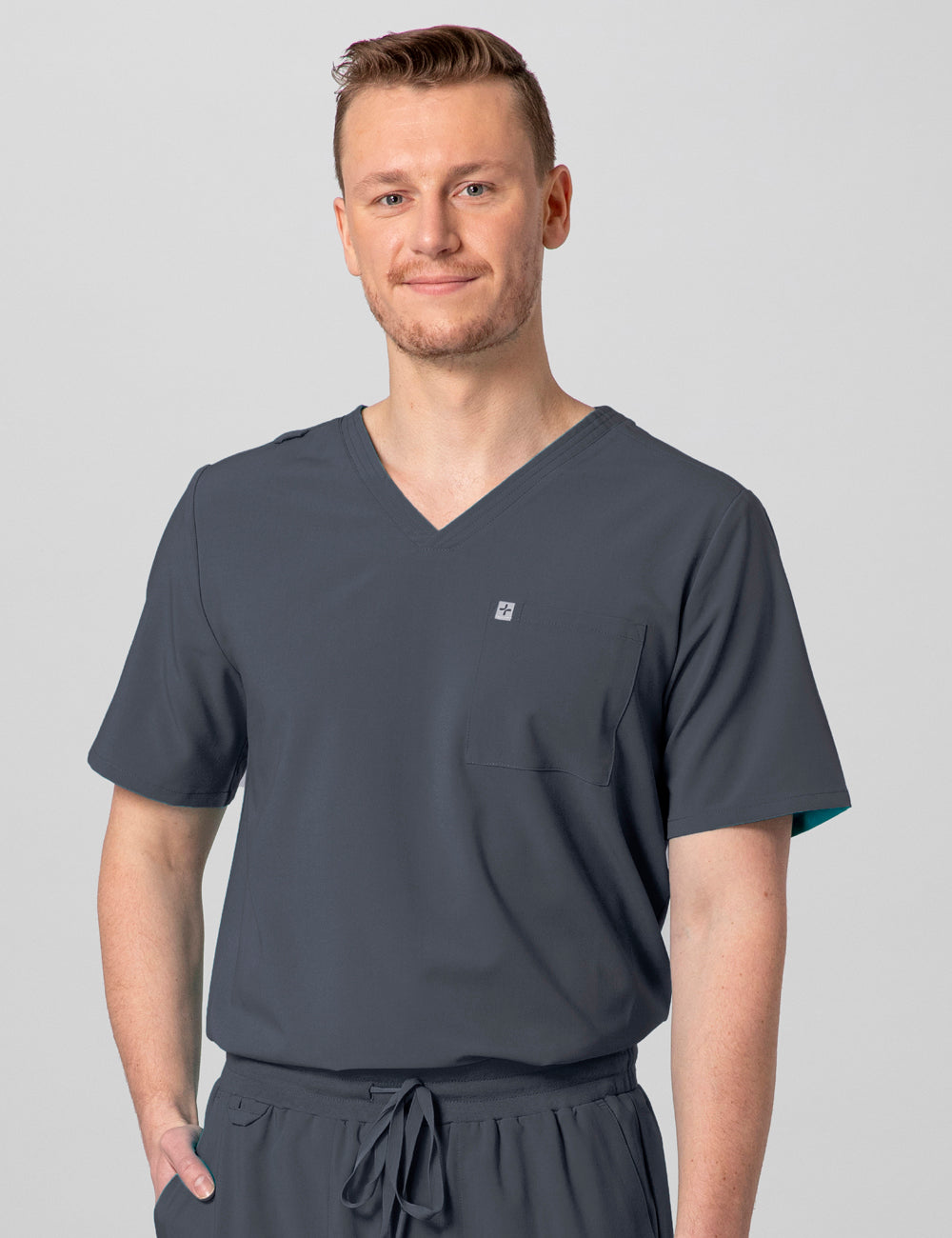 Pewter men's V-neck scrub top with two pockets, combining style and function for professional wear