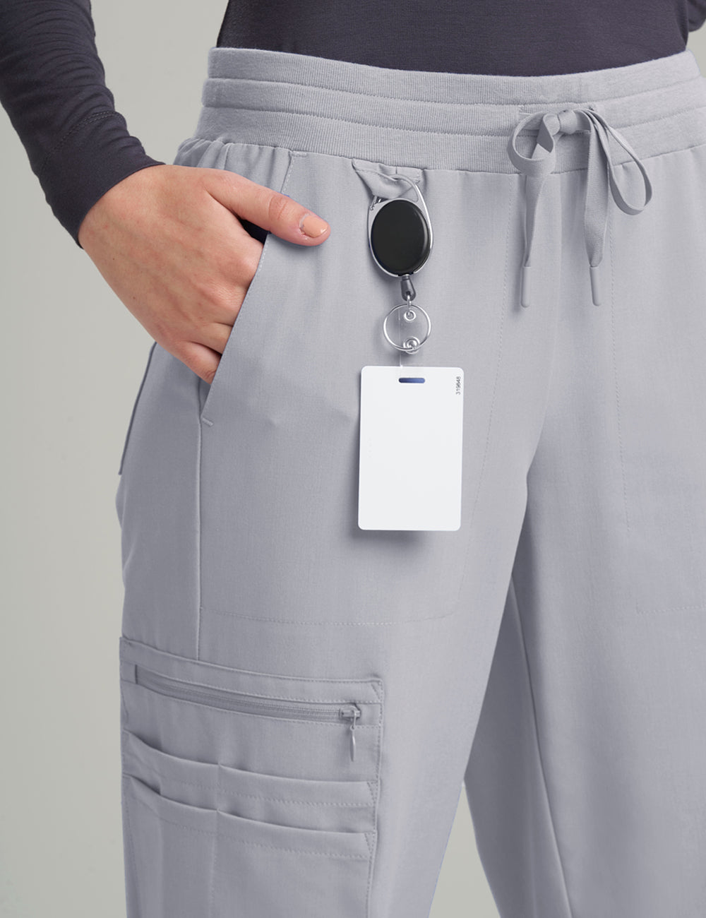 Stone gray women's scrub jogger pants with 12 pockets, offering a modern and functional design