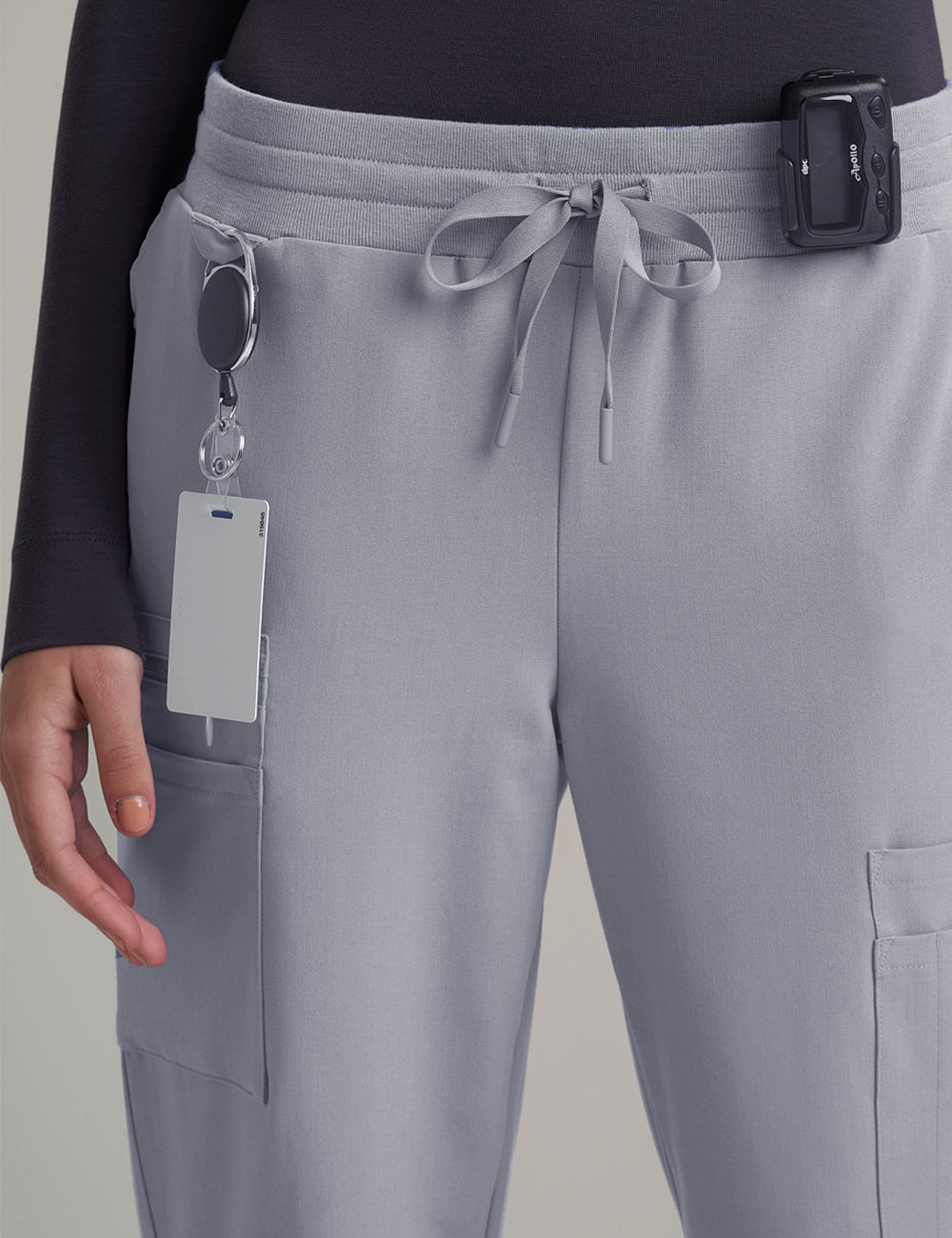 Stone gray women's straight-leg scrub pants with nine pockets, designed for practicality and style