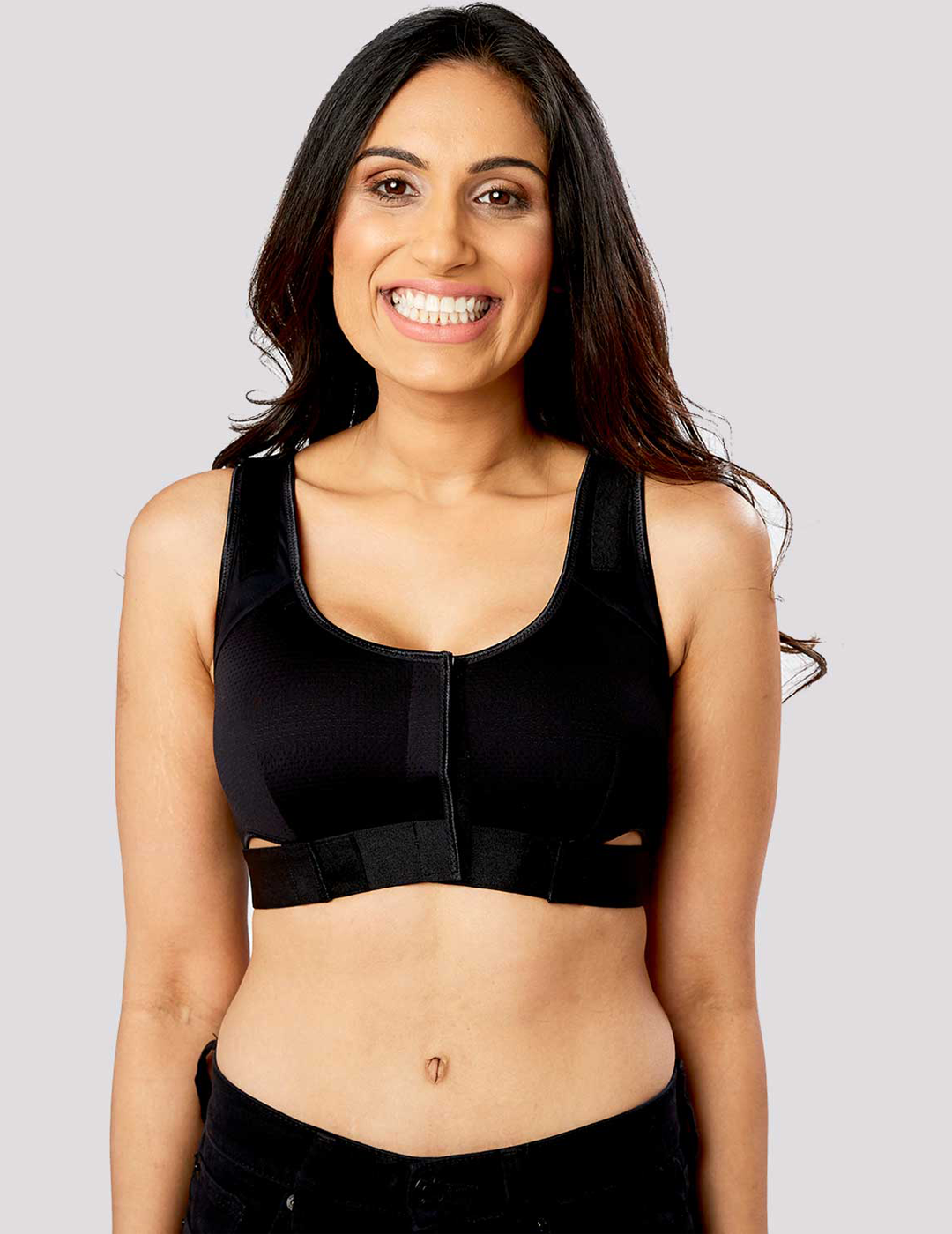 Women's pink The Believer Bra, offering gentle support and a stylish design to enhance post-surgical confidence. Model is wearing size Small