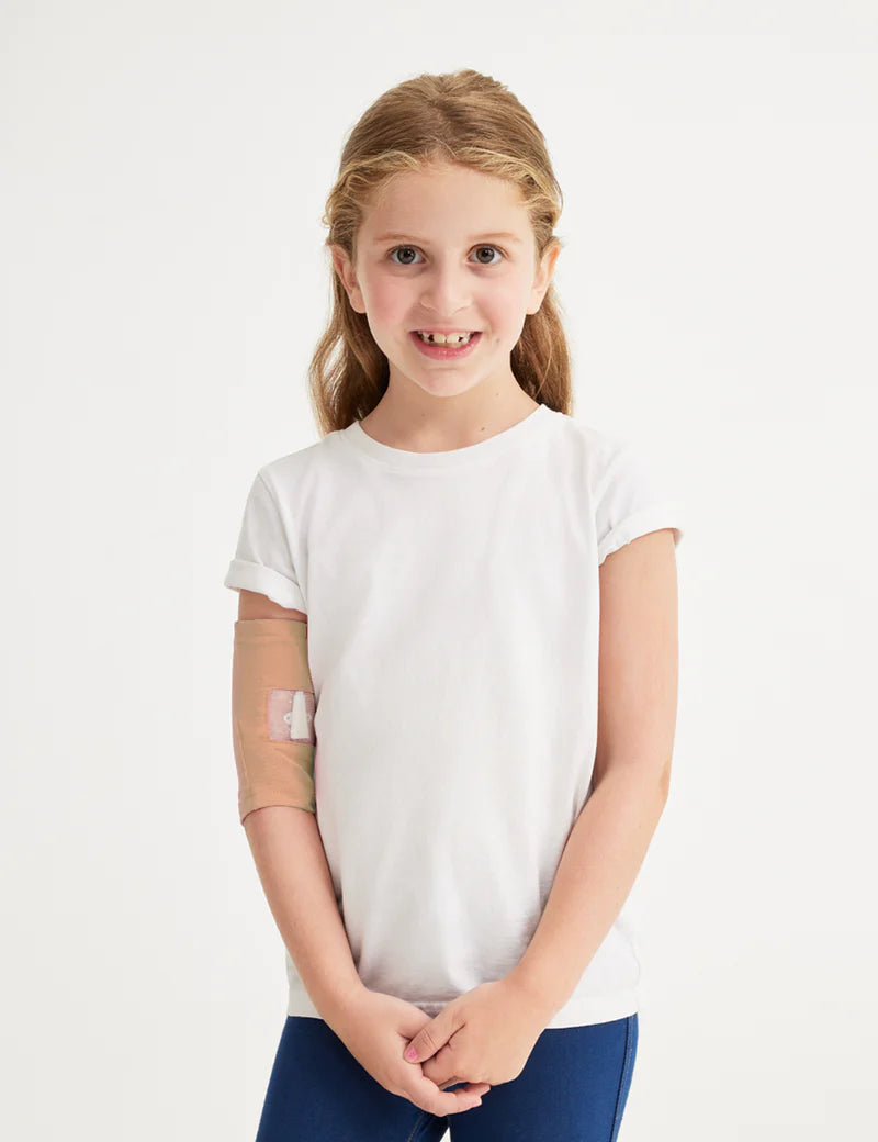 Kids&#39; PICC line cover in camel, providing a neutral and comfortable option for medical support