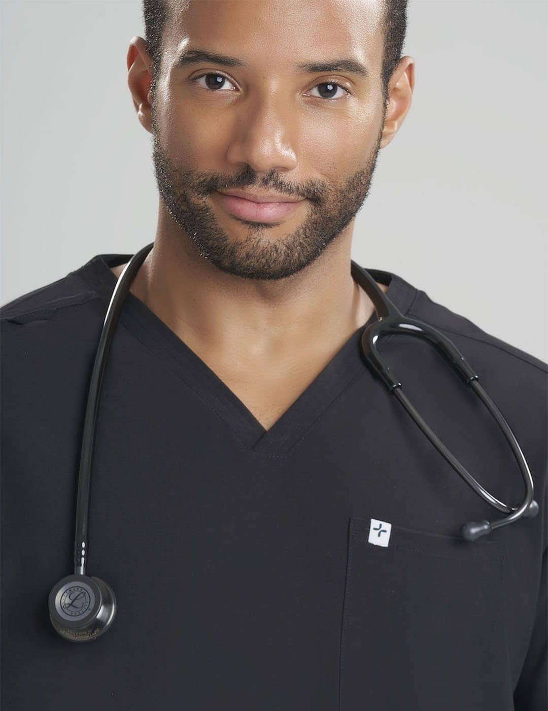 Men's 3-pocket V-neck scrub top in stone gray, offering a sleek look with practical storage.
