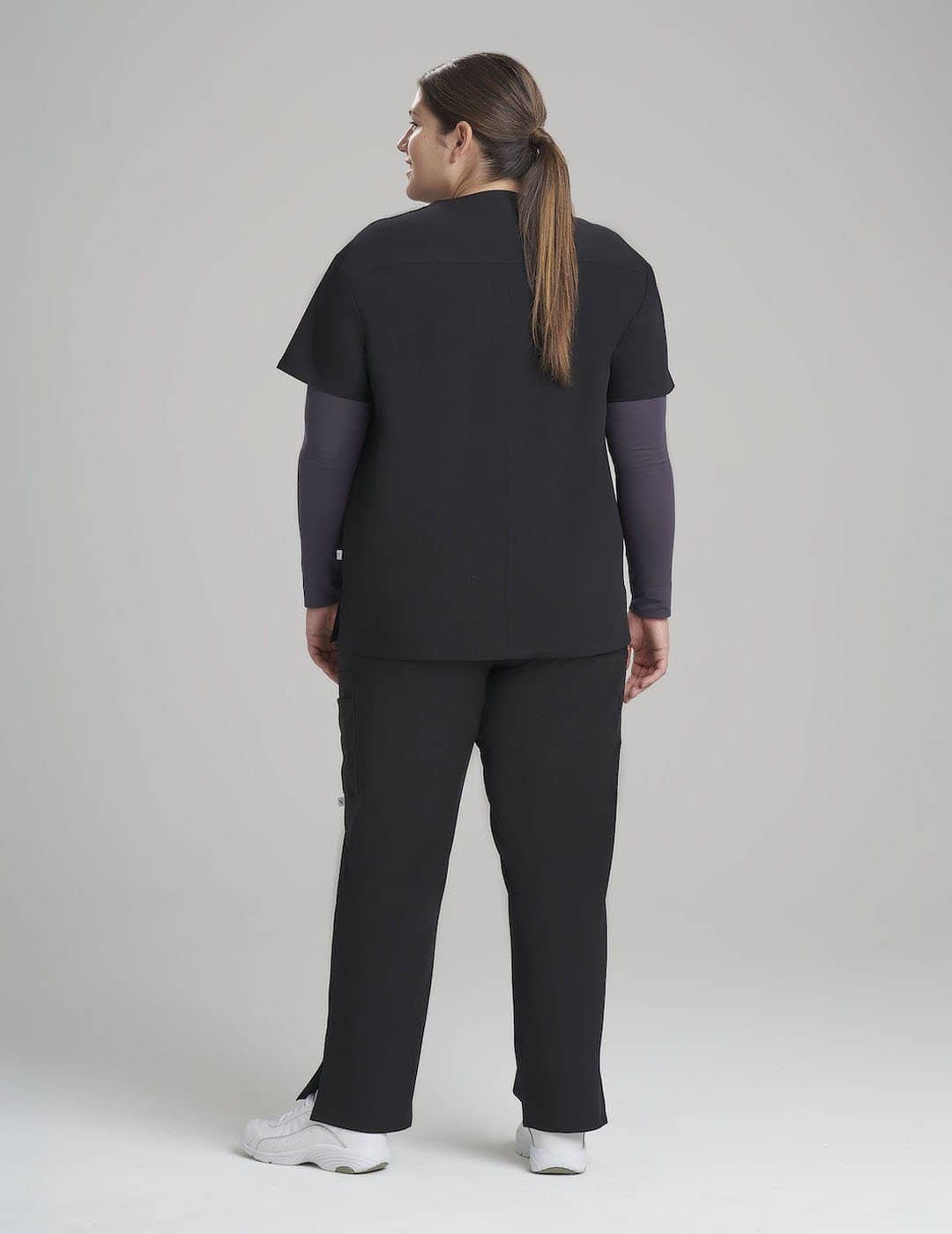 Women&#39;s 3-pocket V-neck scrub top in pewter, combining sleek style with practical storage for healthcare settings.