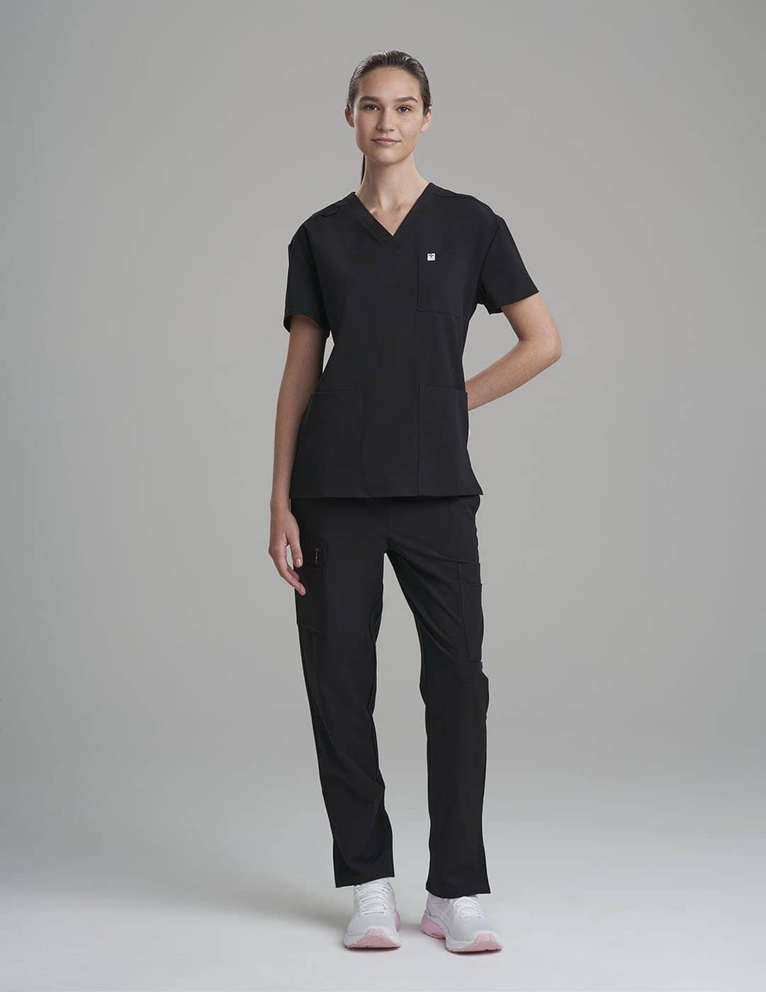 Women&#39;s 3-pocket V-neck scrub top in stone gray, offering a versatile design for healthcare professionals.