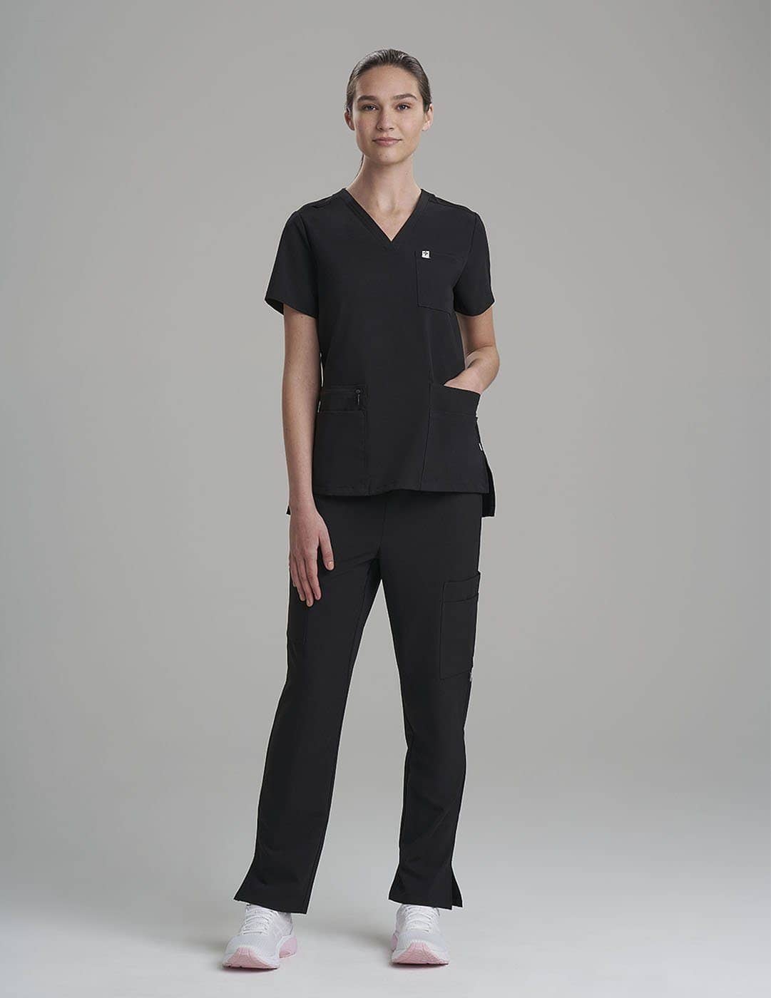 Functional V-neck scrub top in royal blue, designed with six pockets for easy access to essentials. Model is wearing size X-Small