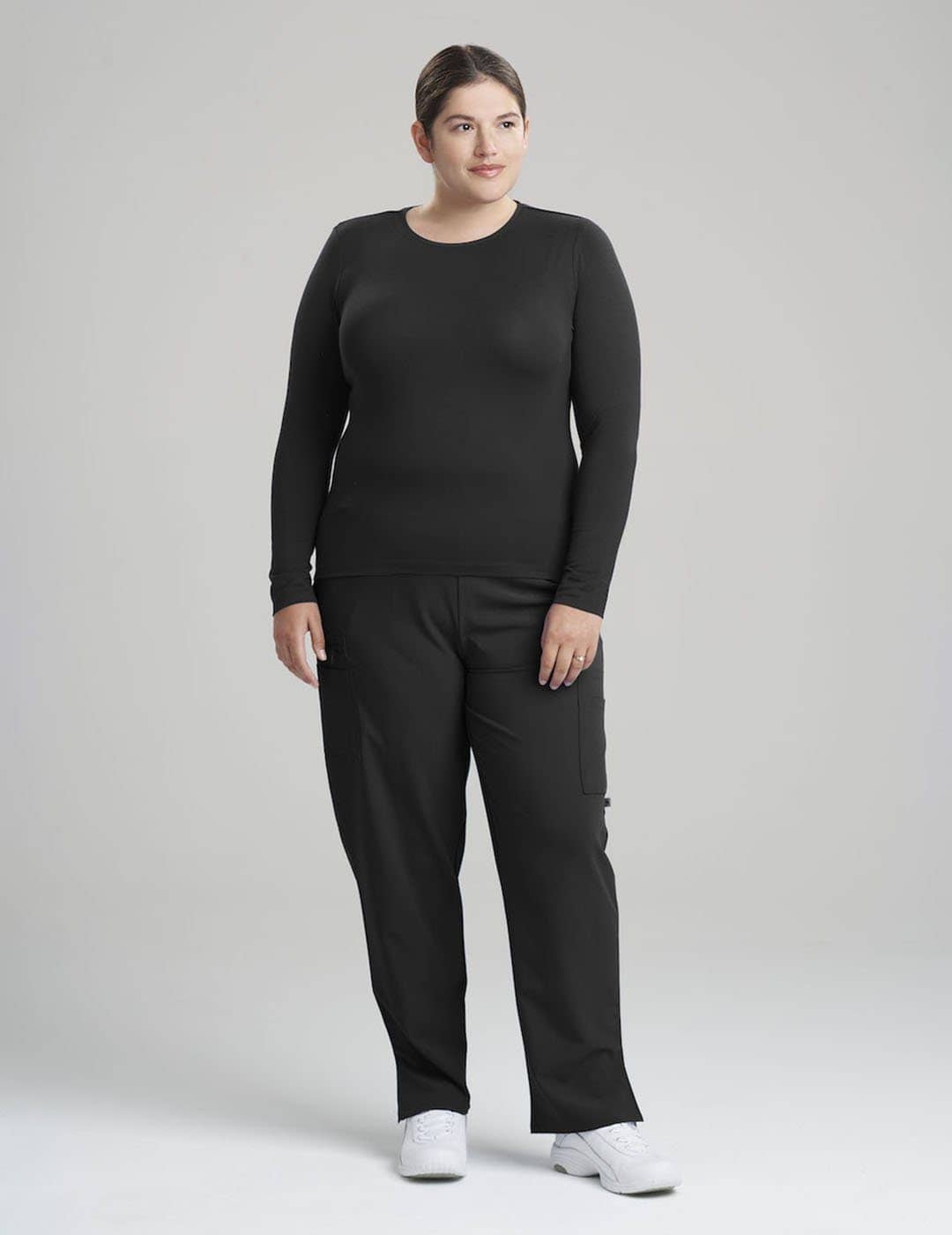 Elegant black long sleeve Luxe underscrub shirt for women, designed with premium fabric for layering. Model is wearing size Large