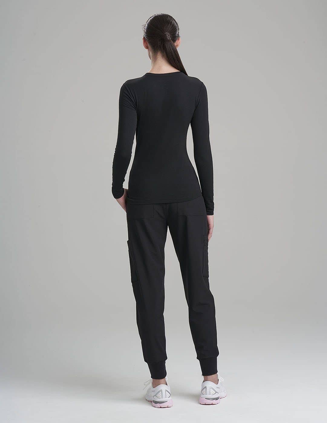 Women&#39;s Luxe long sleeve underscrub shirt in black, offering sleek style and all-day comfort.