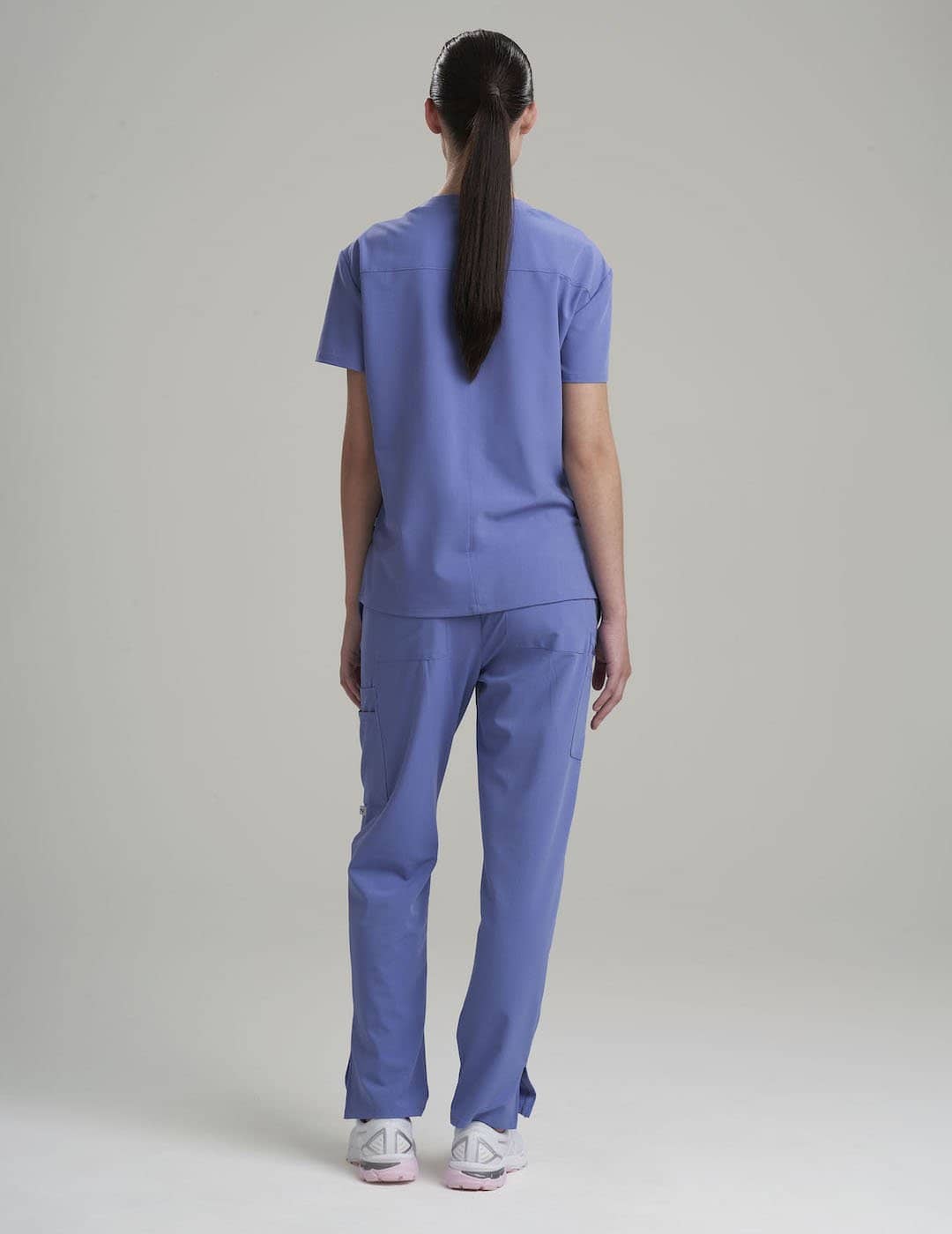 Comfortable women&#39;s scrub top in limited edition ceil, featuring three pockets and a sleek fit for professional wear