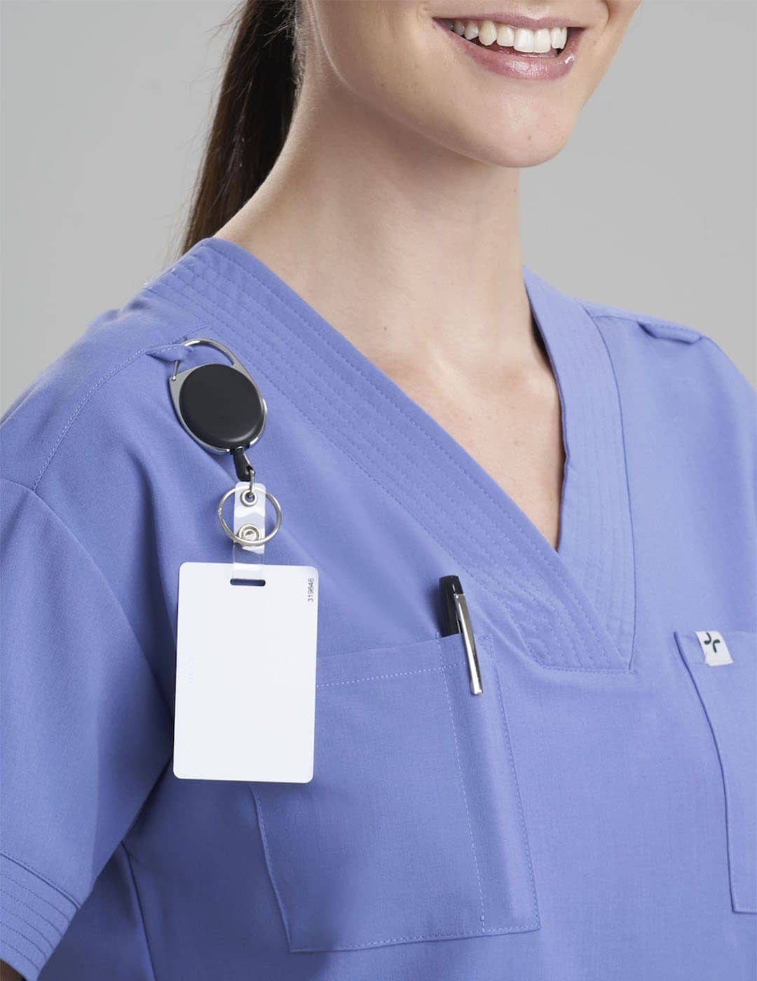 Women's 8-pocket V-neck scrub top in ceil, offering professional style and ample storage. Model is wearing size X-Small