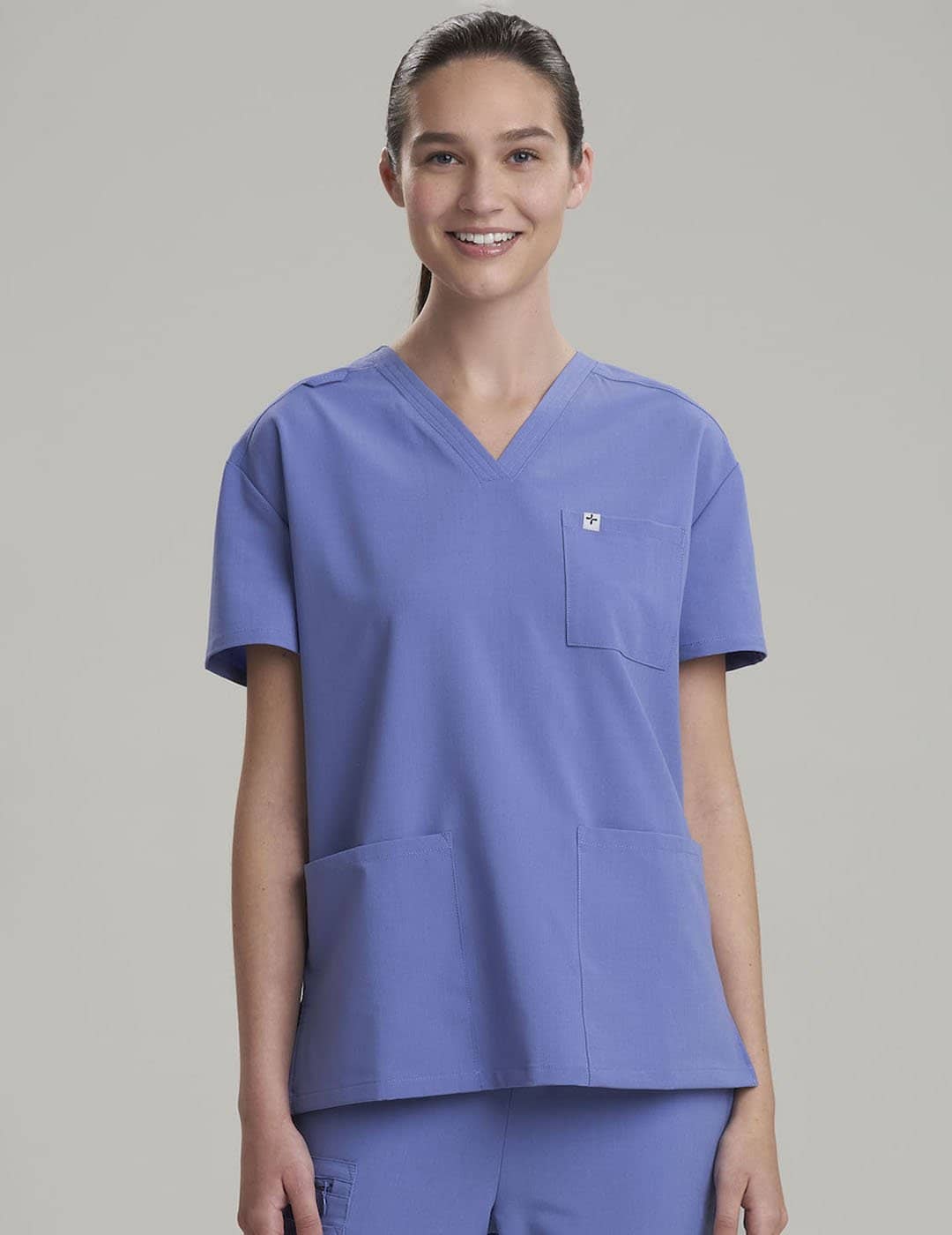 Women&#39;s V-neck scrub top in ceil, providing a clean and professional style for long shifts