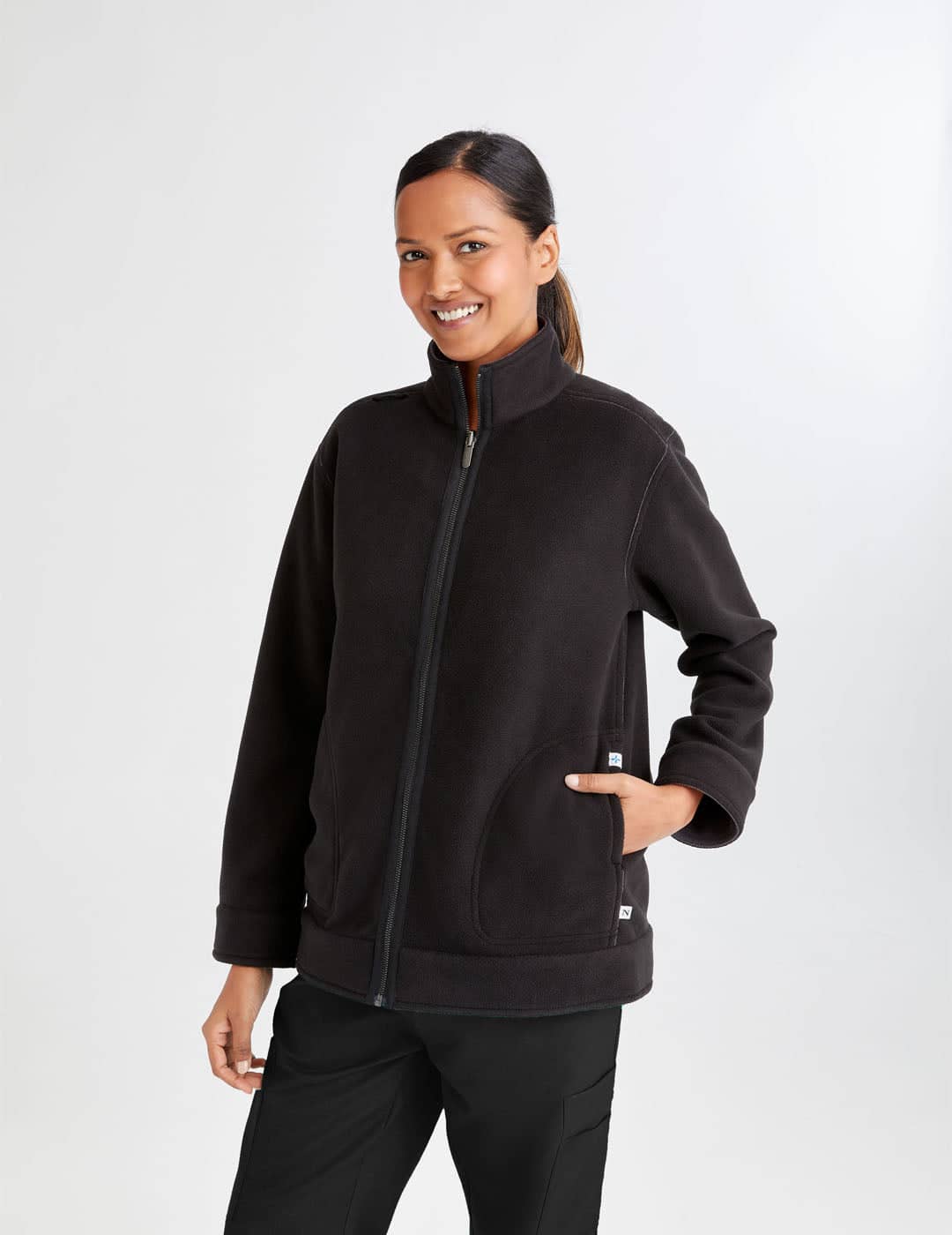 Women's reversible fleece jacket in black and gray, offering dual-color versatility and cozy warmth. Model is wearing size Medium