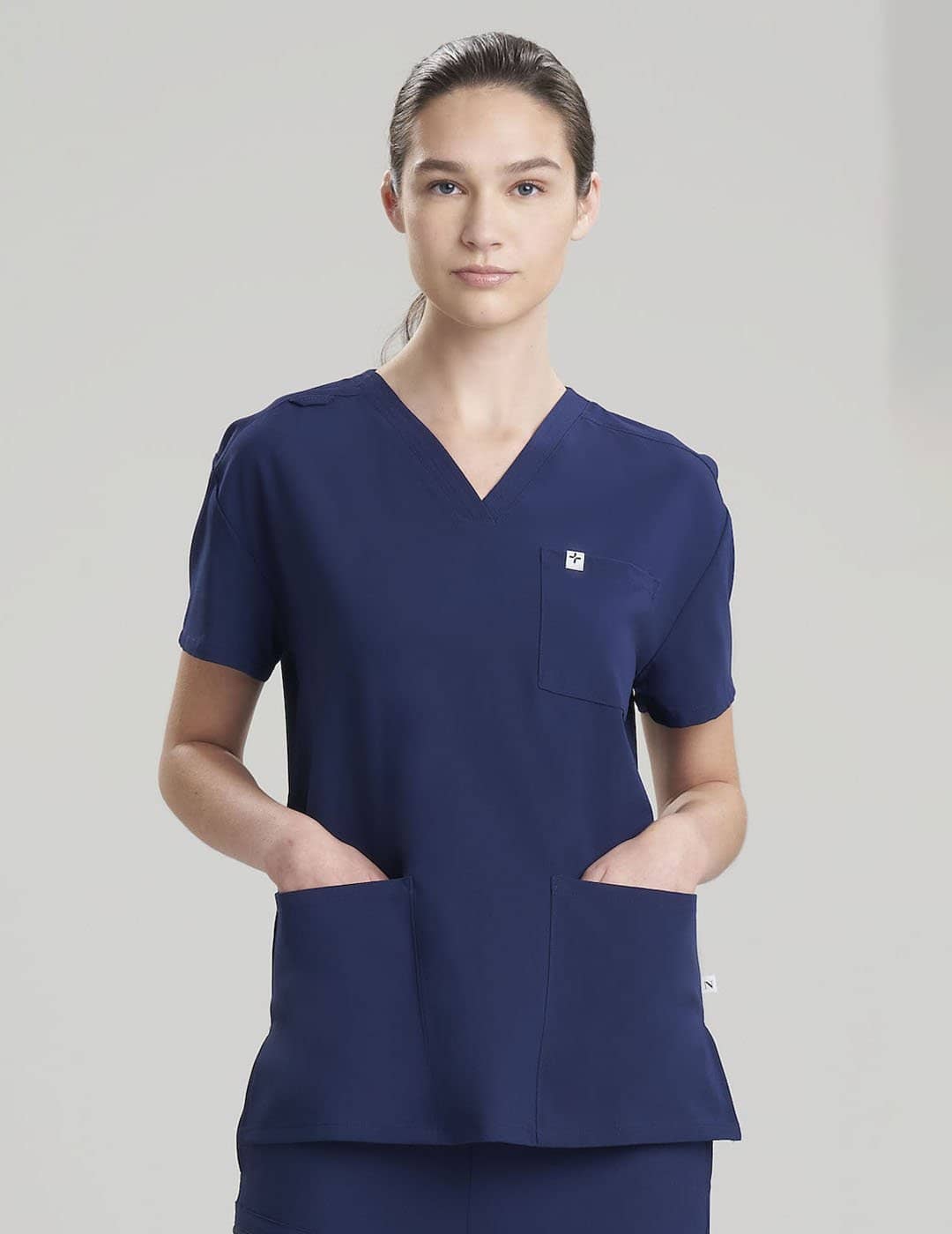 Women&#39;s V-neck scrub top in navy, featuring a classic design with comfortable functionality