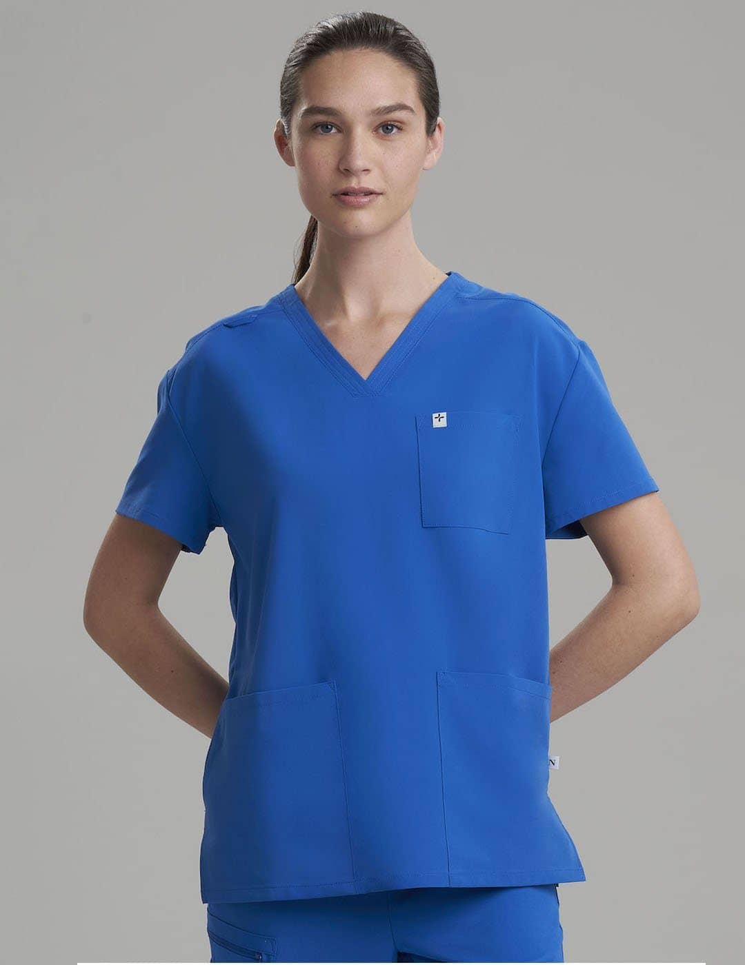 Women&#39;s V-neck scrub top in royal blue, combining bold style with a functional fit for long shifts