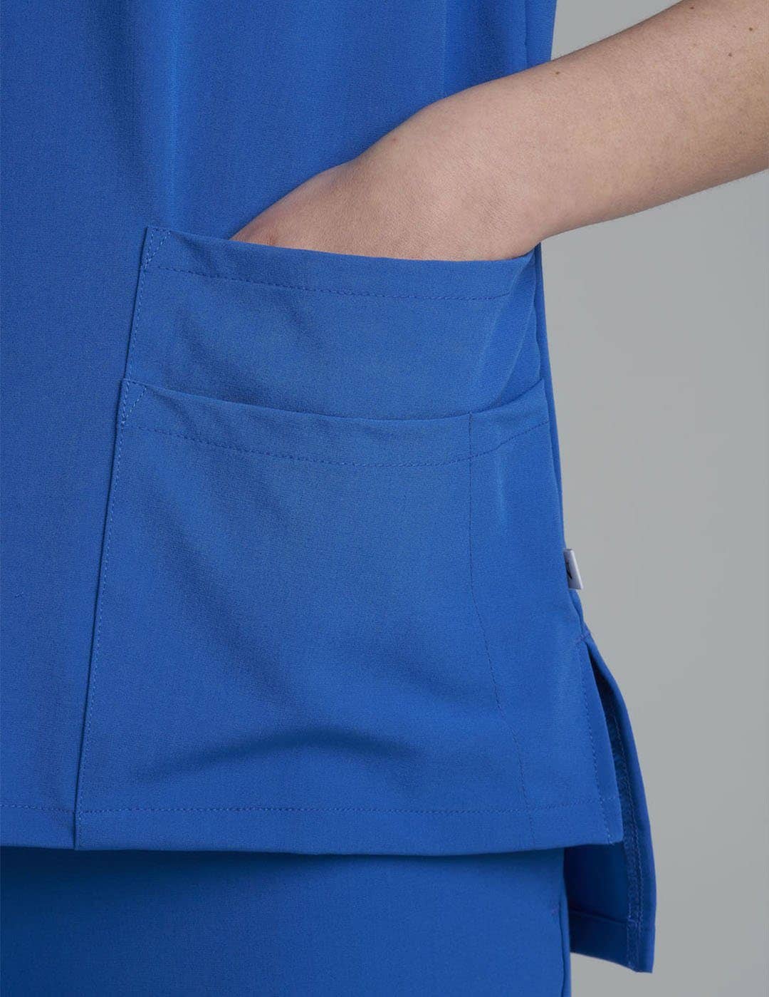 Ceil women's scrub top with six pockets, blending style and functionality for medical professionals. Model is wearing size X-Small