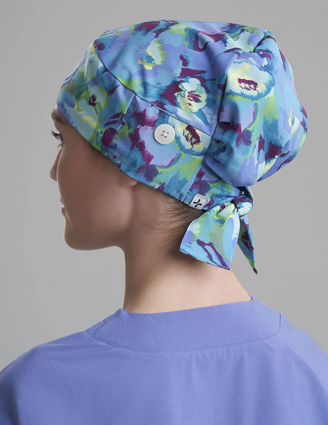 Women&#39;s surgical scrub cap in Brush Flora, showcasing a soft brushstroke floral design for a modern professional look.