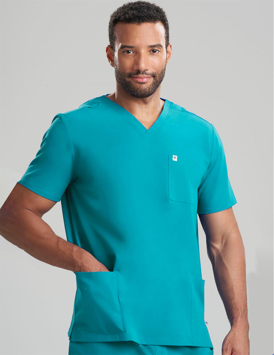 Men&#39;s V-neck scrub top in teal, offering vibrant style with comfort and utility for long shifts