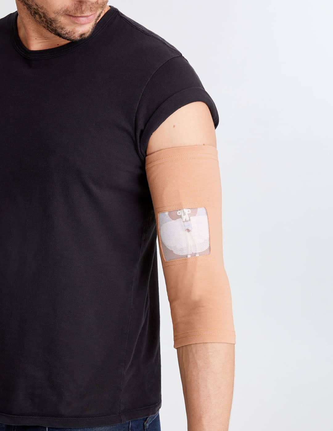 Adult camel PICC line sleeve with ultra grip surface, combining neutral style with functionality. Model is wearing size 11&quot;-13&quot; Bicep