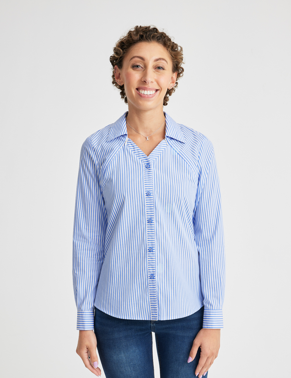 Care+Wear Port Access Button Down Shirt in Blue/White Stripe, combining a classic striped pattern with convenient port access for medical professionals. Model is wearing size Small