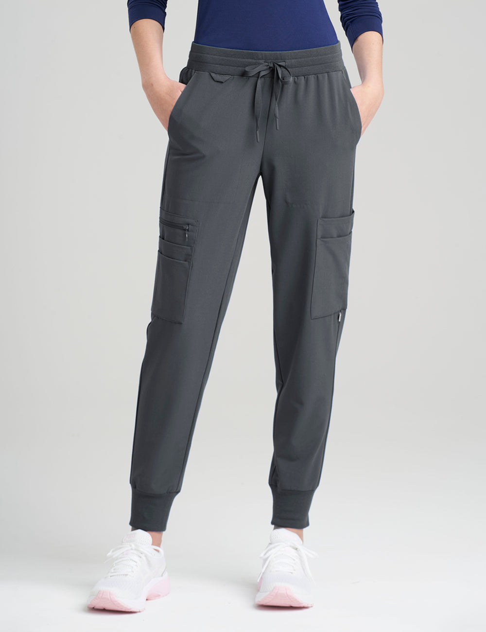 Women's 12-pocket scrub jogger pants in stone gray, offering sleek style and ample storage.